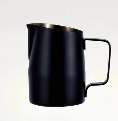 Black milk pitcher with a metallic handle on a white background